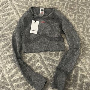 Gymshark size small never worn cropped workout shirt. open back. gray and pink.